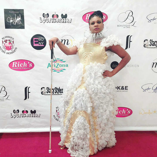 Lachi, a beautiful black woman, poses in a gown with a glam cane